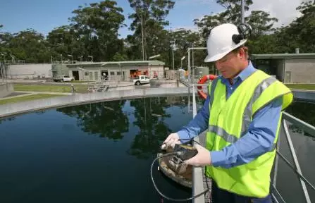 Technician in front of a water basin